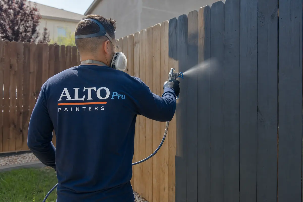 Painter spraying a wooden fence, painters serving Keremeos